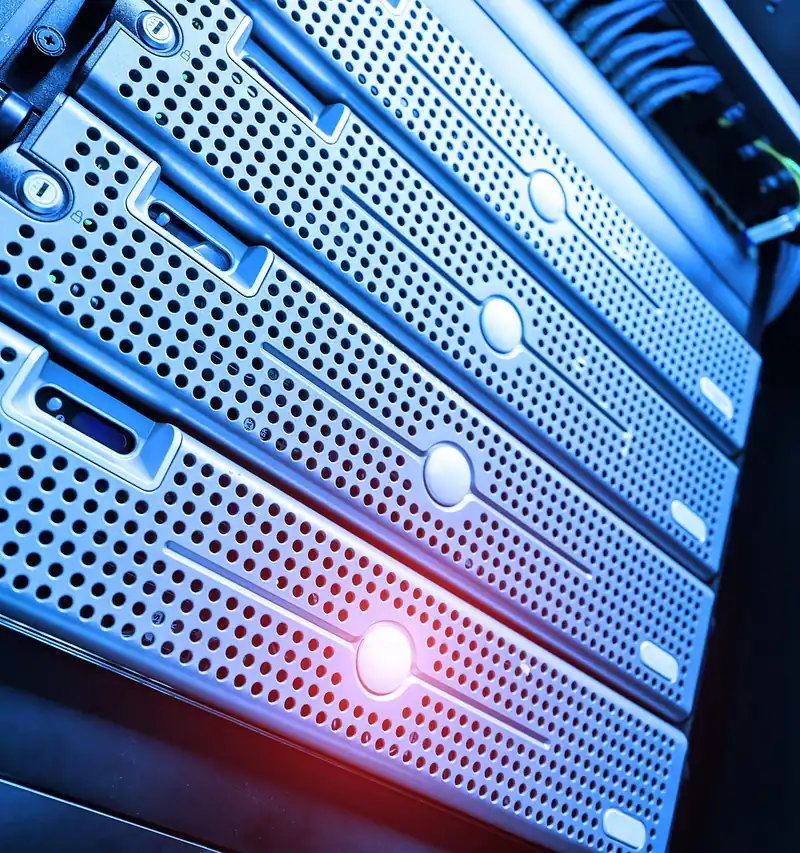Close-up of rack-mounted servers lit in blue with a red status light
