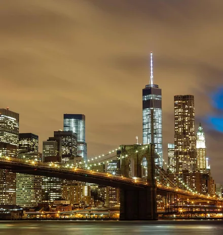 The Brooklyn Bridge and lower Manhattan skyline lit at night